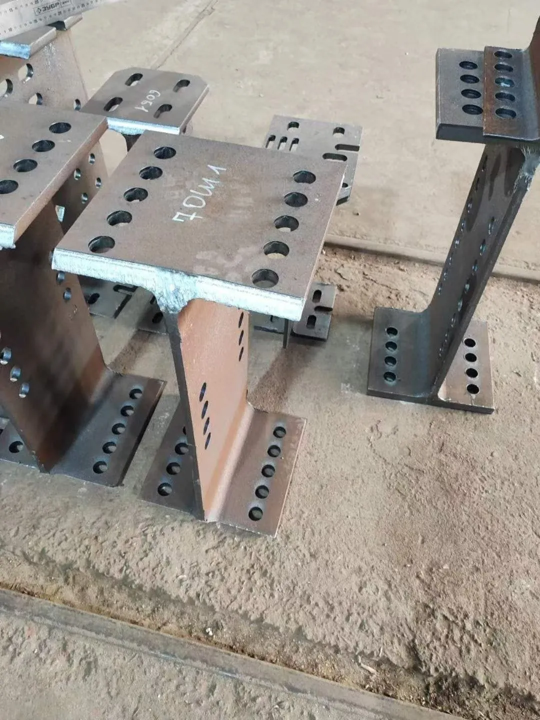 Laser cut H-beam columns with round and slotted holes and part marking