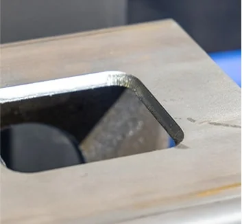Edge of a laser cut rectangular opening in thick steel plate
